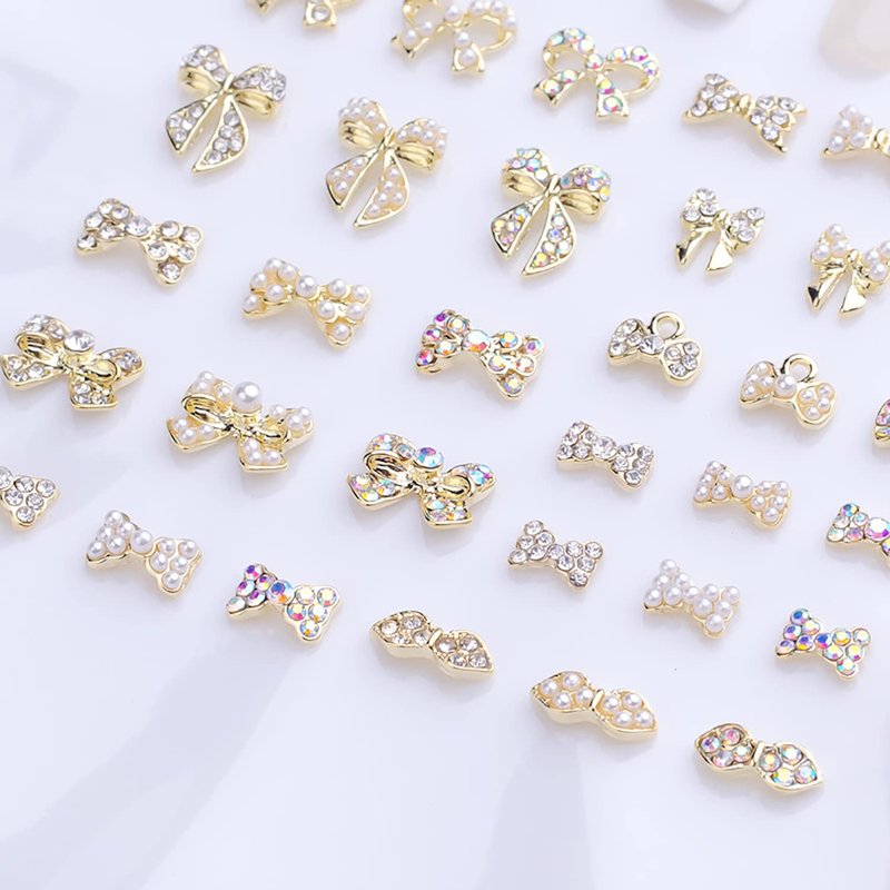 JERCLITY 33 Pieces Gold Alloy Bow Charms for Nails Bow Nail Charms Gems Bowknot Nail Studs Inlaid Pearl Clear Iridescent Rhinestone for Women Nail Art